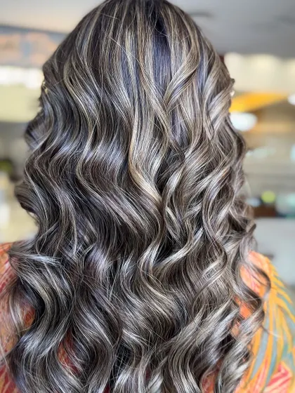 A balayage with brown, blonde, and face-framing highlights. This look is perfect for the festive season, adding a touch of glamour and fun.