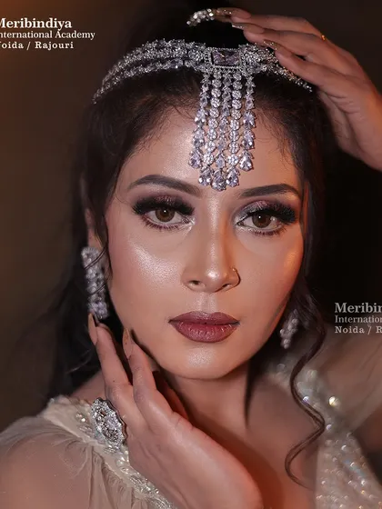 An elegant engagement look featuring a stunning diamond-studded headpiece on softly styled hair.