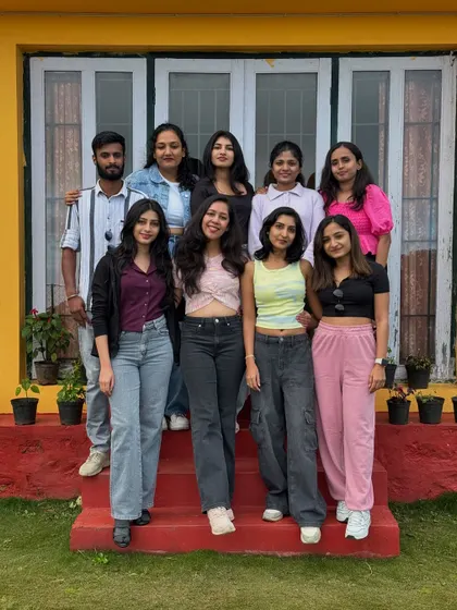 Another group shot on the steps of our cheerful yellow homestay.