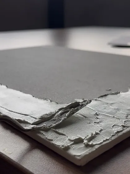 A close-up of the textured art process. We use a thick paste to build up layers on the canvas before adding color, creating a tactile and visually striking artwork.