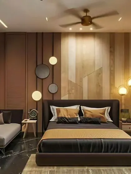 This bedroom design uses a warm, earthy color palette with wood-panelled walls and varied textures. The inclusion of a chaise lounge provides a comfortable spot for relaxation.