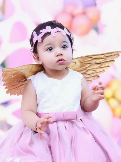 Dressed like a little angel for her first birthday. We love capturing the details of the special outfits and themes you choose for your child's party.