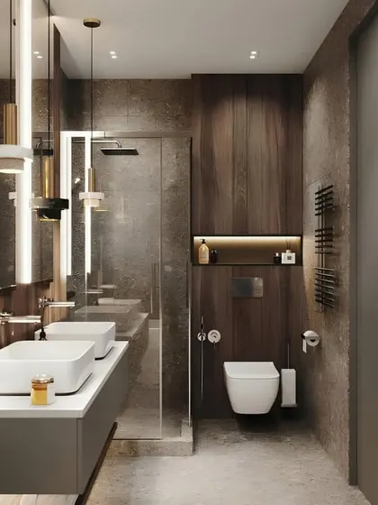 A luxurious bathroom with dark, textured wall tiles and a double vanity with two vessel sinks. The modern pendant lights and back-lit shelving add layers of light and sophistication.
