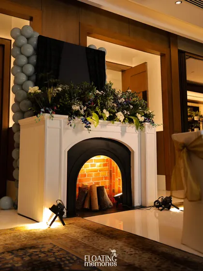 We can create cozy and thematic elements anywhere. This faux fireplace, topped with a lush floral garland, added a warm and inviting touch to the lounge area of the birthday celebration.