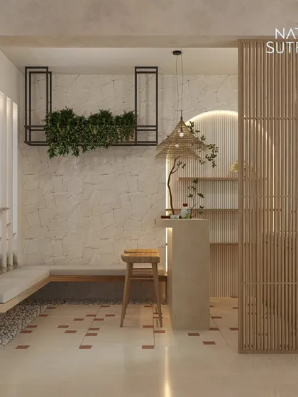 A wider perspective of the home bar and seating nook. The design features a pebble-lined floor border, a built-in bench, and hanging planters, creating a space that feels both organic and highly curated.