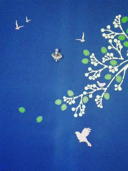 This tree mural on a blue wall is a great way to create a focal point. I can customize colors and elements to fit any room's existing decor.