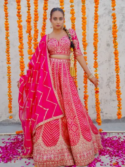 Unveil your beauty with this stunning hot pink lehenga. The gota patti work and bandhani-style dupatta make it a perfect blend of Rajasthani and modern aesthetics.