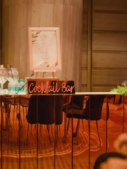 A chic cocktail bar setup for the engagement party. We pay attention to every detail, from the custom menu signage to the elegant glassware, ensuring a cohesive and stylish experience.