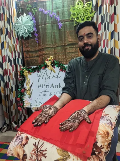 A happy groom showing his full mehendi design. This is a great option for grooms who want to participate fully in the tradition.
