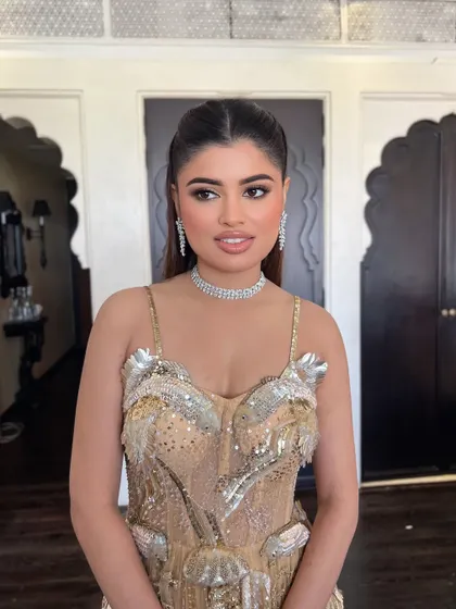 A close-up of the bride, her sleek hair complementing her modern, embellished gown.