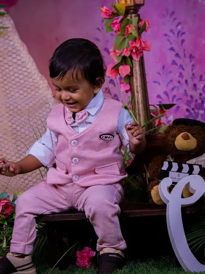 A soft and gentle first birthday theme in our pastel garden. The large "One" sign, teddy bear, and bench create a sweet scene for capturing this important milestone.