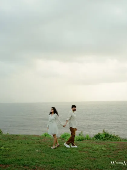 A quiet moment of connection on a Goan cliffside, with the vast ocean behind them. This shot captures the feeling of starting a journey together, just the two of you against the world.