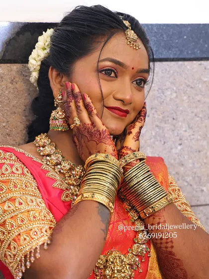 A joyful moment captured. This bride is wearing a beautiful antique gold set with matching bangles, perfect for her wedding ceremony.