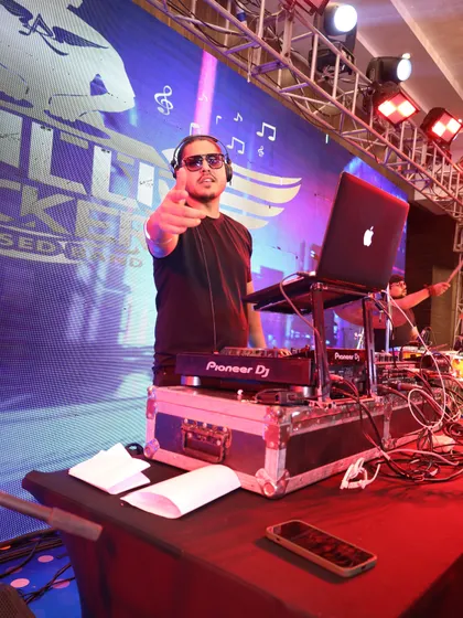 Our DJ, pointing at the crowd, ready to take their requests and feel their vibe. He's an expert at reading the room and playing the perfect track at the perfect time.