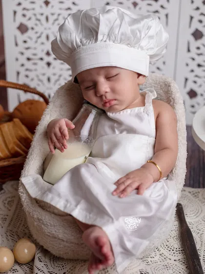 A little high on milk! This tiny baker has fallen asleep on the job, dreaming of sweet treats.