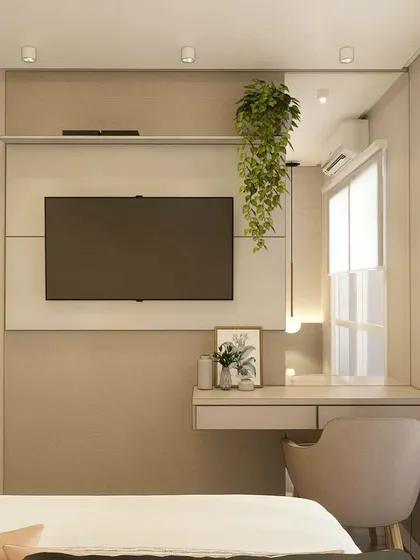 A bedroom with an integrated study desk and TV unit, showing a space-saving design for modern homes.