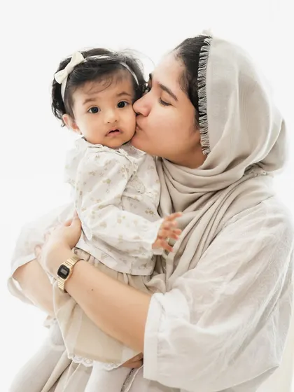 The gentle love of a mother's kiss. We focus on capturing these simple, profound gestures of affection during our family photoshoots.