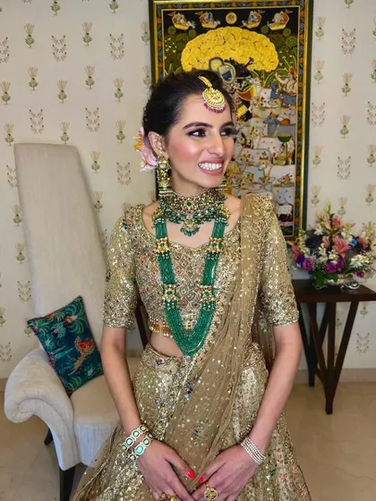 A full-length view of the bride, showing how the floral bun completes her magnificent bridal outfit.