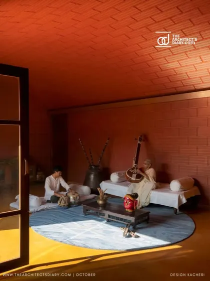 A moment of music and connection in the Madhura house. The earthy material palette of terracotta and stone creates a warm, acoustically rich environment.