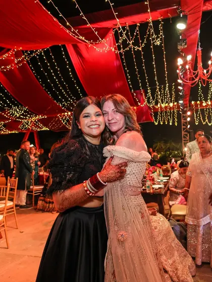 A grand reception under a canopy of red drapes and fairy lights. This setting for Sonam and Ross at Amitarasa was designed to feel both grand and intimate, a perfect space for conversations and making memories.