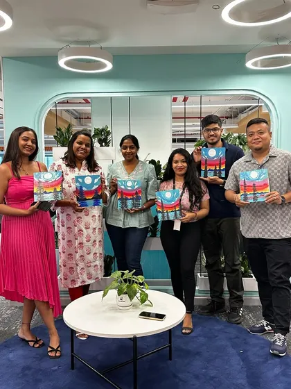 The G2 team proudly showing off their colorful puzzle paintings. A successful and fun event.