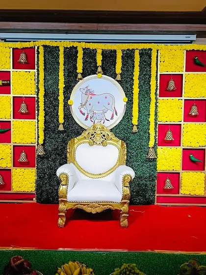 A classic Seemantham backdrop with yellow marigold panels and a central elephant motif. The design is simple yet traditional, perfect for an intimate baby shower ceremony.