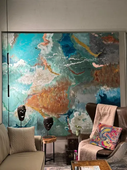 A closer view of the 7ft by 8ft abstract canvas in its final setting. The artwork's colors and textures interact with the room's lighting and decor, creating an immersive visual experience.