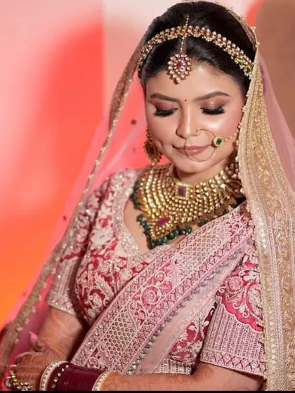 A serene shot of the bride, looking down with a gentle smile.