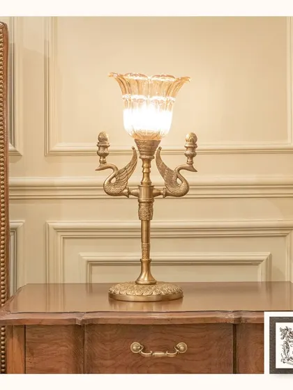 A sophisticated bedside lamp featuring a glass tulip shade and a brass base with swan-like details. This piece adds a touch of artistry and warm light to a classic bedroom setting.