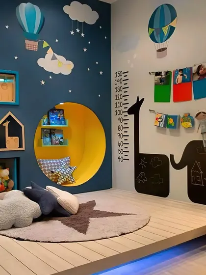 A whimsical playroom and bedroom featuring a cozy reading nook built into the wall, a growth chart decal, and chalkboard panels for endless creativity.
