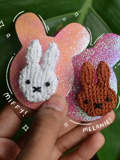 My Miffy and Melanie matching pins displayed on a sparkly, custom-cut backing card. I love making the presentation as cute as the product.