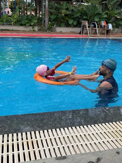 A father teaches his daughter to swim in our pool. It's moments like these that make a family trip special, and our pool is a great place for safe, supervised water fun.