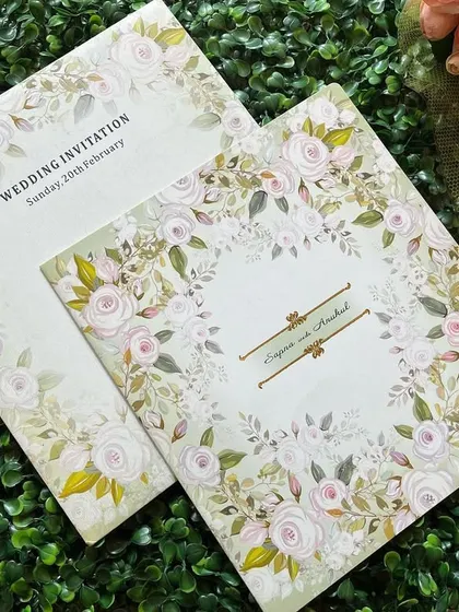 A beautiful invitation with a wreath of white roses. The design is clean, fresh, and can be customized with your initials.