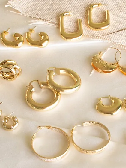 A flat lay of our go-to hoops for any occasion. This image showcases the variety in our collection, from classic round hoops to modern rectangular designs.