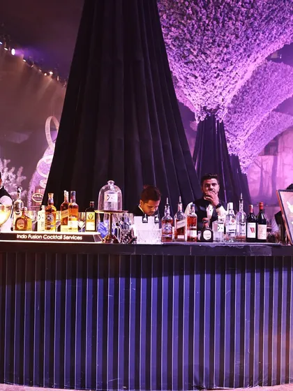 Our bar setups are as sophisticated as our food. This fully stocked bar, manned by professional mixologists, was a central feature of a high-end corporate gathering, serving classic cocktails and bespoke creations.