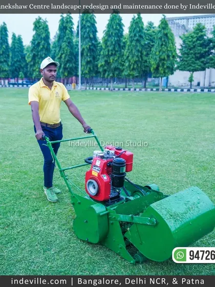 A duplicate image of my staff member professionally mowing the lawn at Manekshaw Centre.