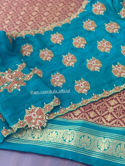 The full view of the teal blouse, showing the scattered motifs.
