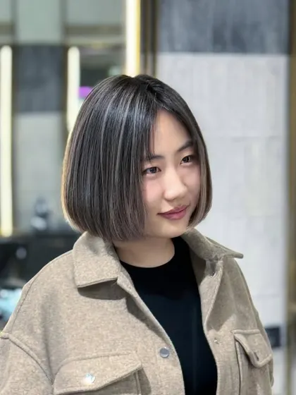 A chic ash-toned bob with subtle highlights. This look is modern, sophisticated, and proves that good hair makes for a good day.