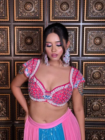 A modern and edgy ponytail with face-framing pieces. This style is perfect for a Sangeet or cocktail party, complementing a bold and colorful outfit.