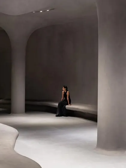 An interior view of the Aatma Manthan Museum, designed for self-reflection. The space features organic, cave-like forms with smooth, rendered walls and integrated seating, creating a serene and contemplative atmosphere.