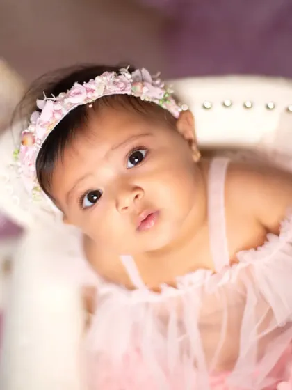 A beautiful close-up portrait from a unicorn-themed sitter session, capturing the baby's innocent gaze.