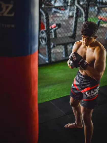 Preparing for the next round. A fighter takes a moment between drills with the heavy bag, demonstrating the focus required in our training.
