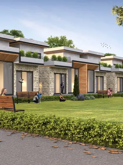 A row of luxury villas designed as part of a larger housing development. The design focuses on creating a community feel with shared lawns and seating areas, while each villa has its own private space.
