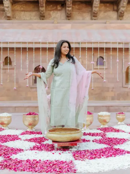 The bride looking radiant and happy during her traditional Chooda ceremony in a Rajasthani palace courtyard.