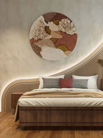 We designed this bedroom around organic forms and tactile surfaces. The custom-designed, wave-like headboard with integrated backlighting creates a soft, sculptural feature wall, complemented by the textured plaster and warm wood tones for a serene atmosphere.
