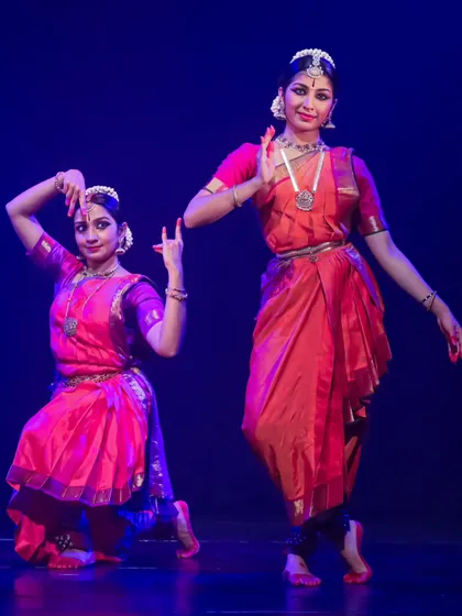 This image captures the narrative aspect of a duet. Here, two dancers portray different characters or emotions, their poses telling a story of devotion or dialogue.
