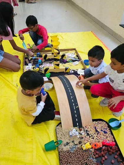 My setups are perfect for birthday parties, encouraging kids to play together and share. Here, a group of friends are completely engaged in our transportation theme, pouring, scooping, and driving cars down the ramp.