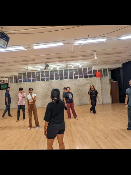 An instructor leads the class, demonstrating a move while students follow along. Our teachers are here to guide you every step of the way.