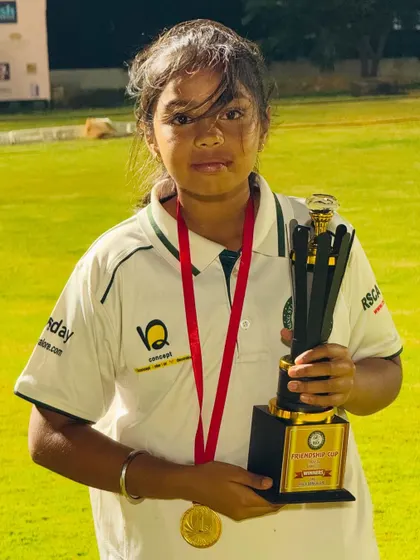 Another one of our talented young female cricketers with her trophy and medal.