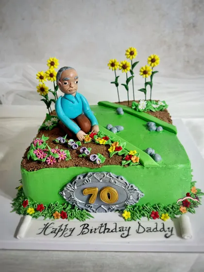 A 70th birthday cake for a dad who loves to garden. I included a hand-sculpted figurine of him tending to his sugar flowers.